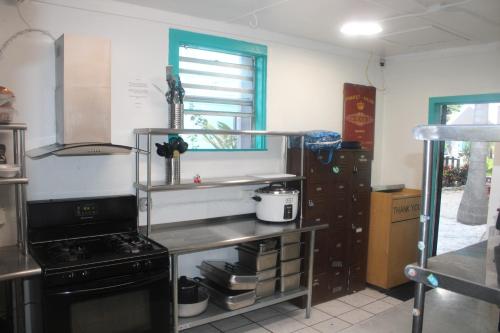 a kitchen with a stove and a stove top oven at Hoosville Hostel (Formerly The Everglades Hostel) in Florida City