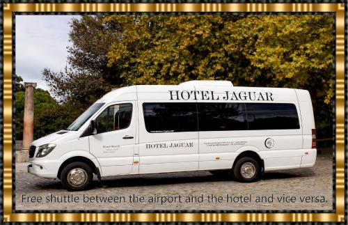 biały van zaparkowany na parkingu w obiekcie Hotel Jaguar Oporto - Airport to Hotel and City is a free Shuttle Service w Porto