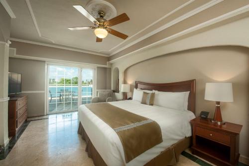 a bedroom with a large bed and a ceiling fan at Villa Mercedes Curio Collection By Hilton in Mérida
