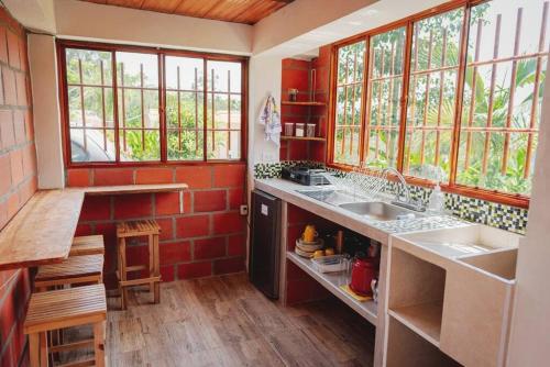 a kitchen with a sink and some windows at Cabaña vacacional en San Gil 'El Mirador' in San Gil