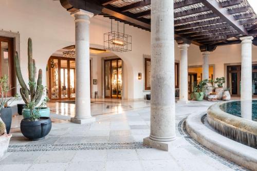 an indoor lobby with columns and a pool at Hilton Grand Vacations Club La Pacifica Los Cabos in Cabo San Lucas
