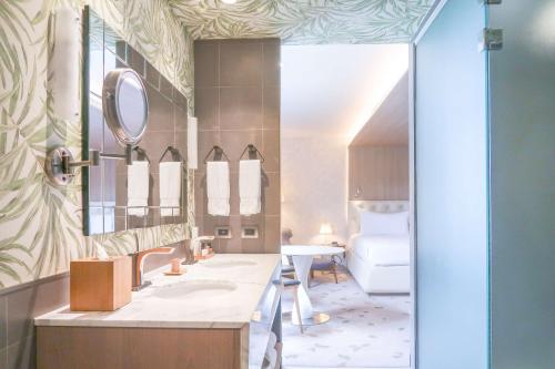 a bathroom with a sink and a mirror at Gran Hotel Costa Rica, Curio Collection By Hilton in San José