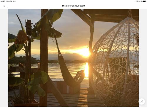 a hammock on a dock with the sunset in the background at Life is Good in Bocas del Toro