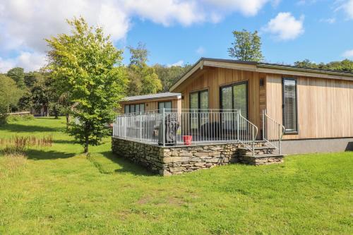 a home with a large porch and a yard at Ash Thwaite in Ulverston