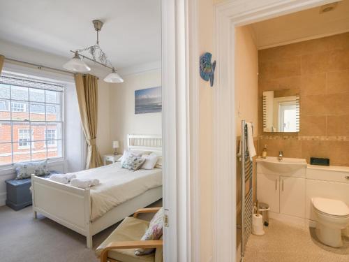 a small bedroom with a bed and a bathroom at Sublyme in Lyme Regis