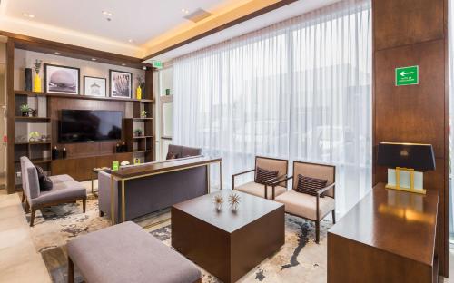 a living room with a large window and a tv at Hampton Inn By Hilton Tijuana in Tijuana