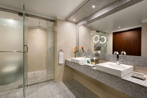 a bathroom with two sinks and a mirror at Hilton Colon Quito Hotel in Quito