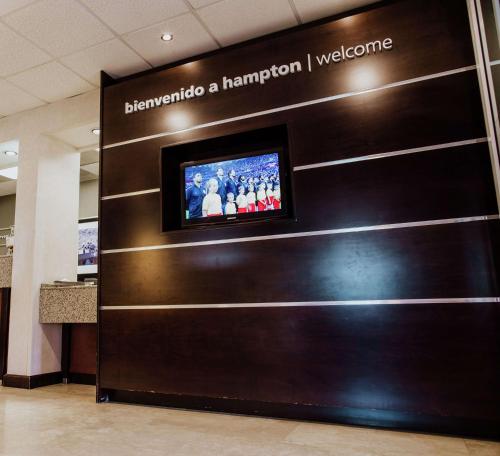 a television on a wall in a building at Hampton Inn Torreon Airport-Galerias in Torreón
