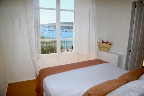 a bedroom with a bed and a window with a view at Can Set in Cadaqués