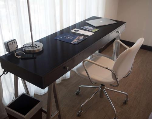 a black desk with a chair and a laptop on it at Hampton by Hilton Santa Cruz in Santa Cruz de la Sierra
