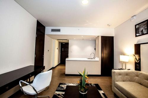 a living room with a couch and a table at Hampton by Hilton Santa Cruz in Santa Cruz de la Sierra