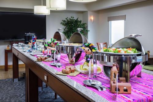 a buffet line with food on a table at Hampton by Hilton San Juan del Rio in San Juan del Río
