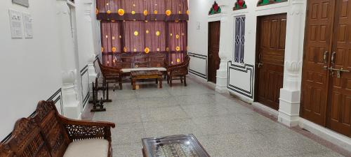 a room with a stage with chairs and a couch at Hotel MSD Niwas in Mandāwa