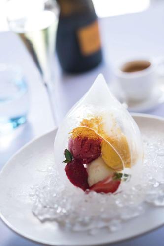 a dessert with strawberries and a lemon on a plate at Hilton Moorea Lagoon Resort & Spa in Papetoai
