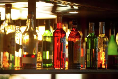 a row of wine bottles sitting on a shelf at Hilton Moorea Lagoon Resort & Spa in Papetoai