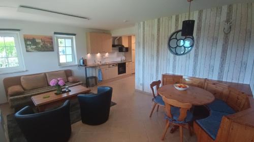 a living room with a table and a couch at Haus Rosaria in Stallhofen