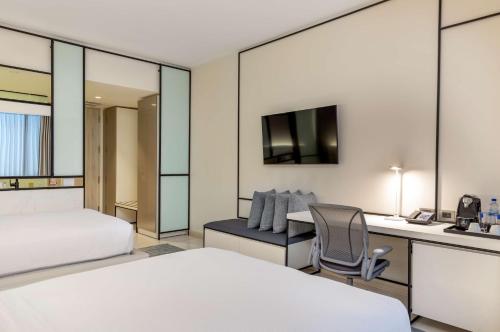 a hotel room with a bed and a desk at Hilton San Jose La Sabana in San José