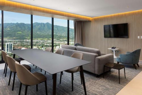 a conference room with a table and chairs and a tv at Hilton San Jose La Sabana in San José