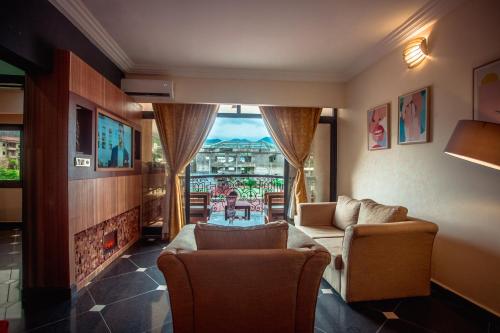 a living room with a couch and a fireplace at Marcsons Hotels and Resorts in Limbe