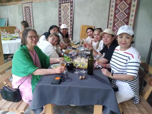 a group of people sitting at a table eating at Maximus Wine Cellar,Bagdati Wine House in Bagdatʼi