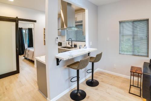 uma cozinha e sala de estar com um balcão e bancos em Pet-Friendly Riverside Vacation Rental with Patio! em Riverside