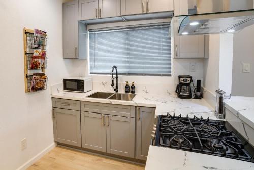 a kitchen with a sink and a stove at Pet-Friendly Riverside Vacation Rental with Patio! in Riverside