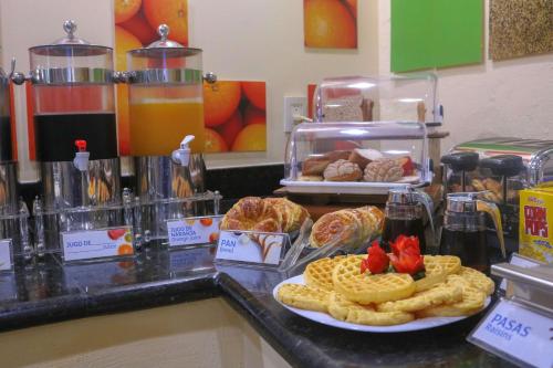 a buffet with waffles and waffle food on a counter at Hampton Inn Tampico Zona Dorada in Tampico