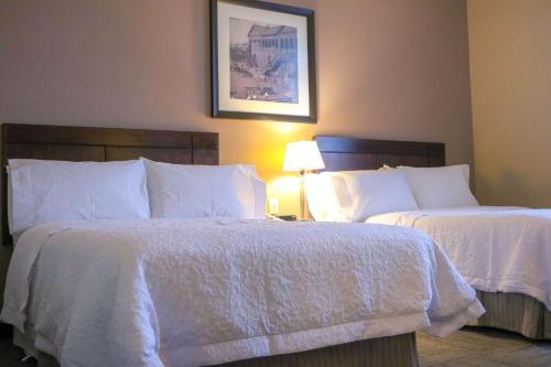 a hotel room with two beds with white sheets at Hampton Inn Tampico Zona Dorada in Tampico