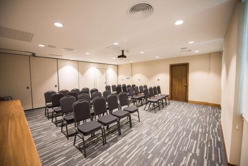 a conference room with rows of chairs in it at Hampton By Hilton Santo Domingo Airport in Boca Chica