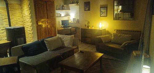 a living room with two couches and a coffee table at La maison sous le Château in Tallard