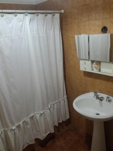 a bathroom with a shower curtain and a sink at C'Aroma de Mujer in San Salvador de Jujuy