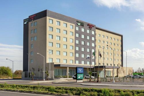 a large building on the side of a road at Hampton Inn By Hilton Monterrey Apodaca in Monterrey