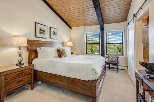 a bedroom with a large bed and a wooden ceiling at Interlude Condominiums 3-Bedroom Unit 308 in Snowmass Village