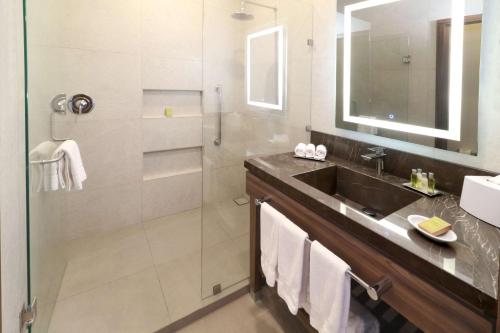 a bathroom with a sink and a shower at Hilton Garden Inn Monterrey Obispado in Monterrey