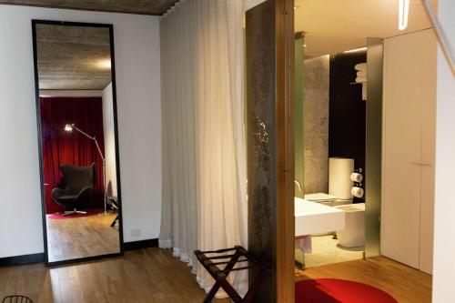 a bathroom with a sink and a chair in a room at Anselmo Buenos Aires, Curio Collection by Hilton in Buenos Aires