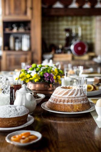 a table with a cake and plates of food on it at Ca' De Memi in Piombino Dese