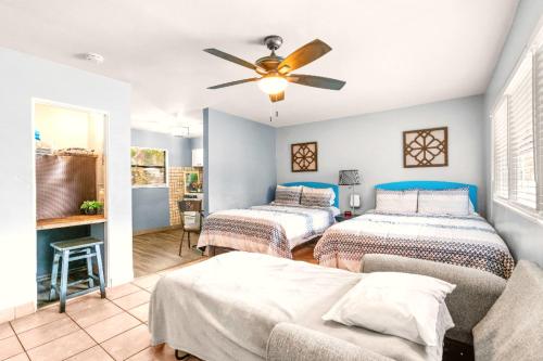 a bedroom with two beds and a ceiling fan at 11 Private Rooms Up To 47 Guests! Hotel Takeover in St Pete Beach