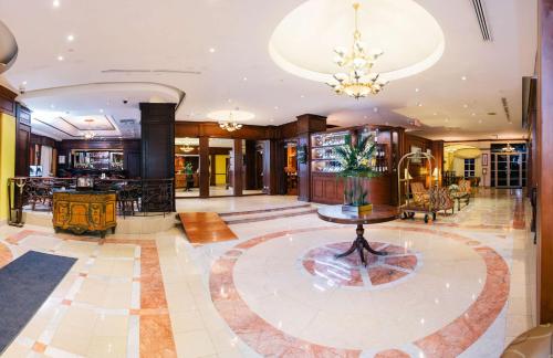 a lobby with a table in the middle of a room at Hilton Princess Managua in Managua