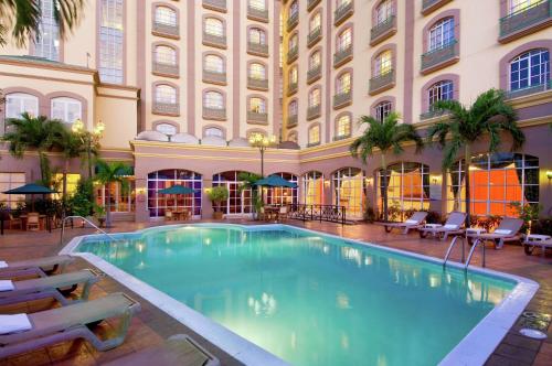 a large swimming pool in a building with a hotel at Hilton Princess Managua in Managua