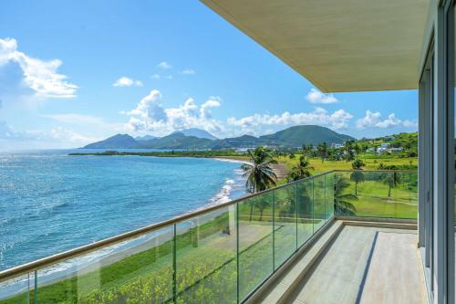 a balcony with a view of the ocean at Koi Resort Saint Kitts, Curio Collection by Hilton in Basse Terre Town