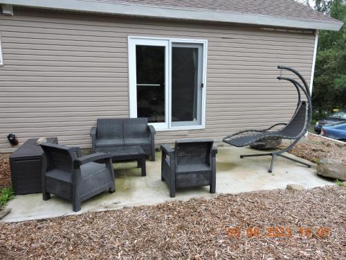 a group of chairs and a grill on a patio at Gite Passion et Tendresse B&B in Shefford