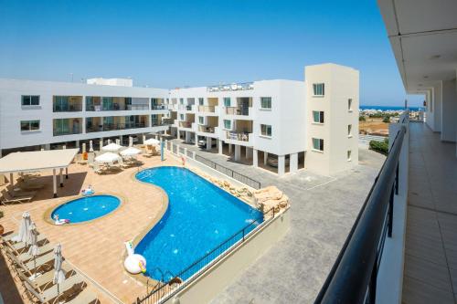 a view of the pool from the balcony of a hotel at SEABREEZE APARTMENT 200m away from the sea in Paralimni