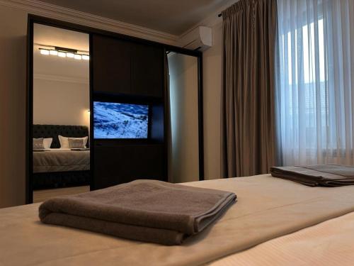 a bedroom with a bed with a television on it at Apartament Adela Giulia in Buzău