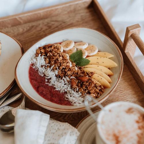 a bowl of food with nuts and fruit on a tray at Hotel Plantación in Jardin