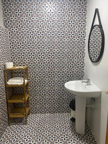 a bathroom with a white sink and a mirror at Hostal Concepción in La Mata