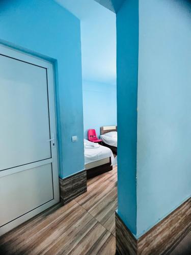 a room with a door and a bedroom with a bed at MarNar Hotel in Yerevan