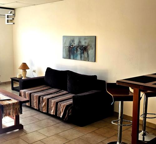 a living room with a couch and a table at Eclat Suites Hotel Boutique in Villa Mercedes