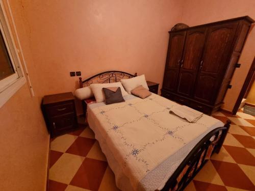 sypialnia z łóżkiem z drewnianym zagłówkiem w obiekcie Apartment in home tafraoute with terrace w mieście Tafraout