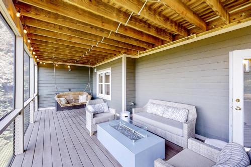 a porch with couches and a coffee table on a house at Jump Off Rock Retreat in Hendersonville