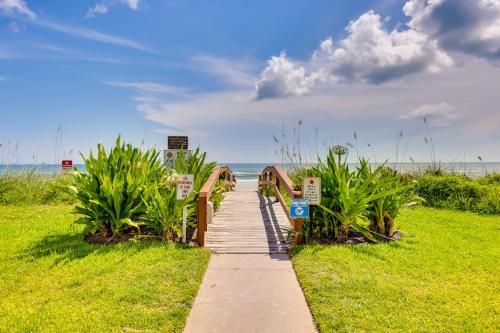 a walkway leading to the beach with a bridge at Beachfront St Augustine Condo with Pool Access in Saint Augustine
